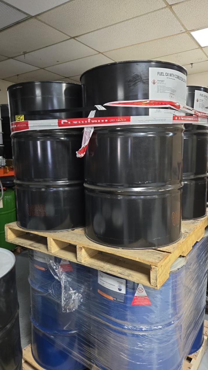 208-litre drums of Fuel Ox combustion catalyst stacked in a warehouse